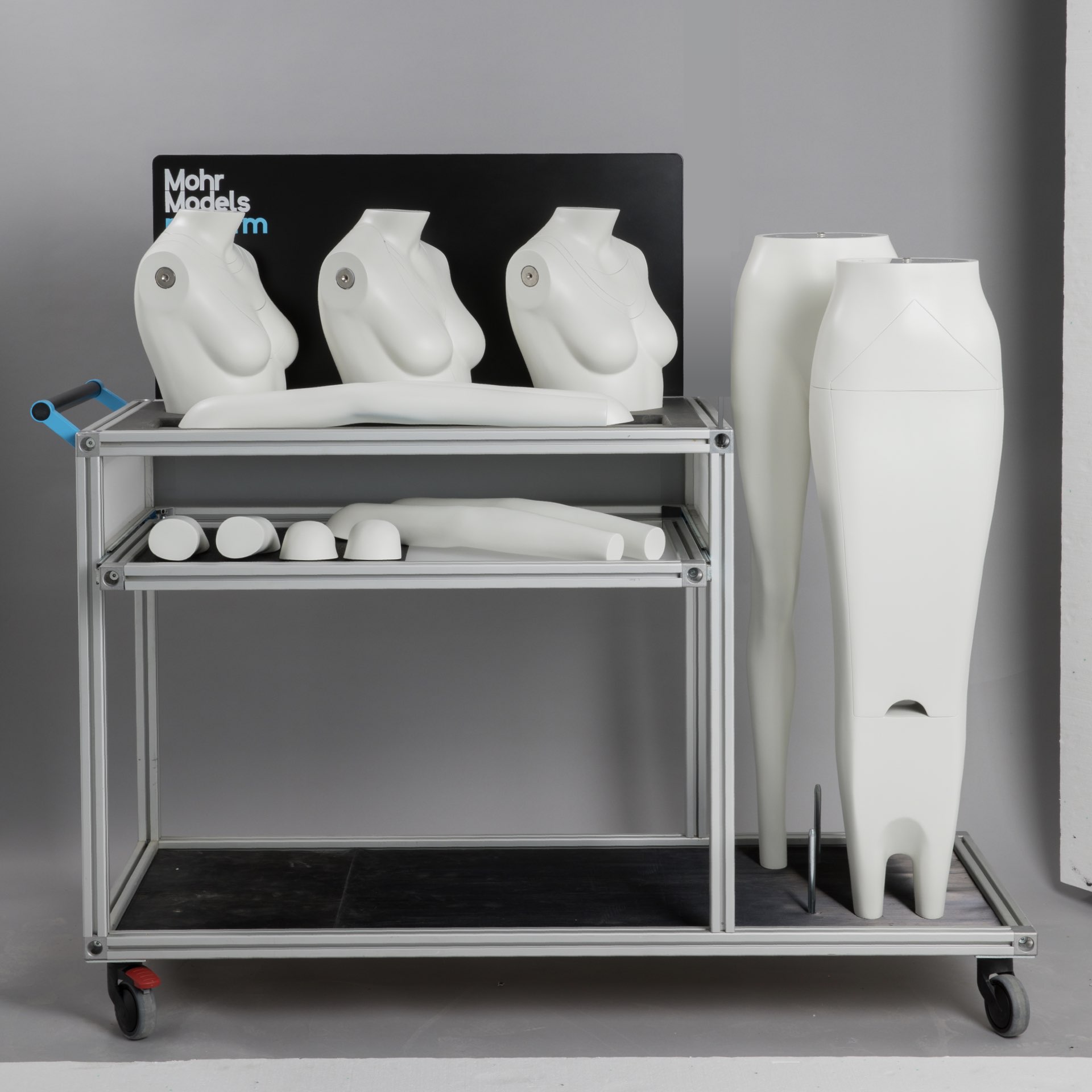Modular Female Ghost Mannequin components neatly arranged on a wheeled aluminum rack